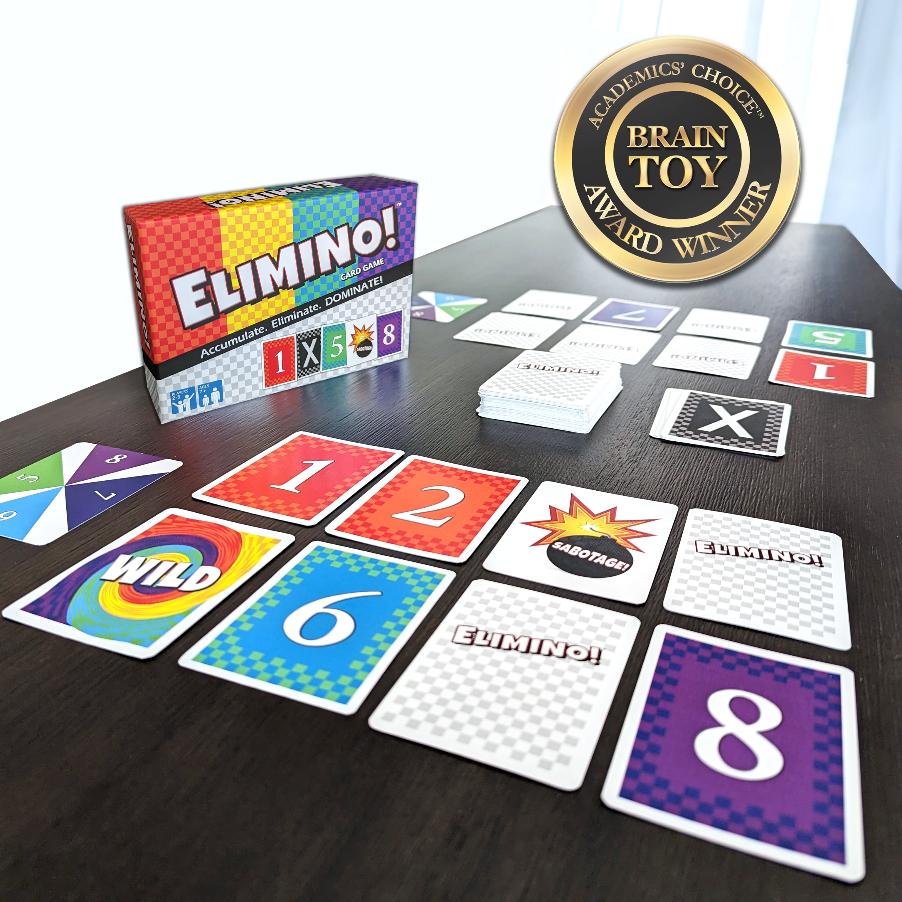 Elimino cards spread on table with visible Brain Toy award