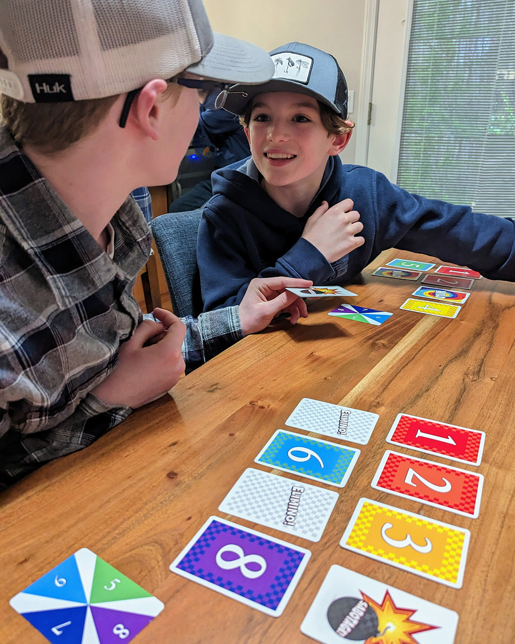 Two boys playing Elimino at a table