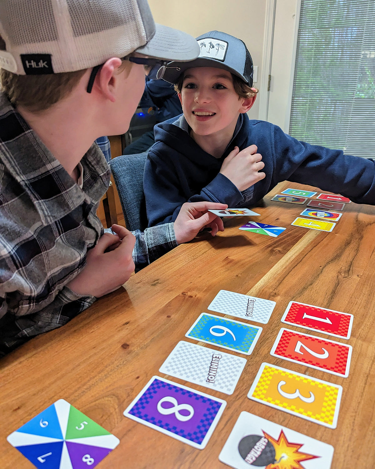 Two boys playing Elimino at a table