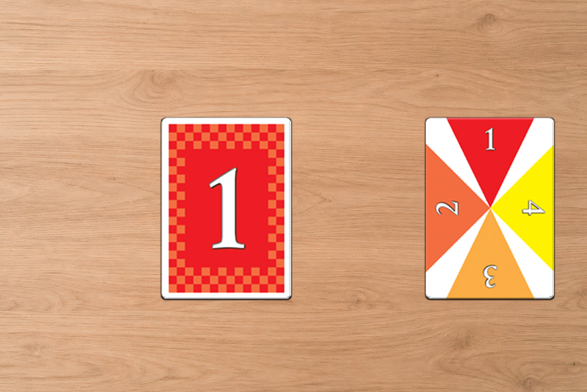 Two playing cards with numbers on a wooden surface